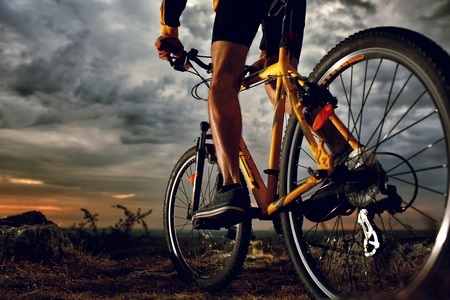 Person Mountain Bike Riding at Dusk