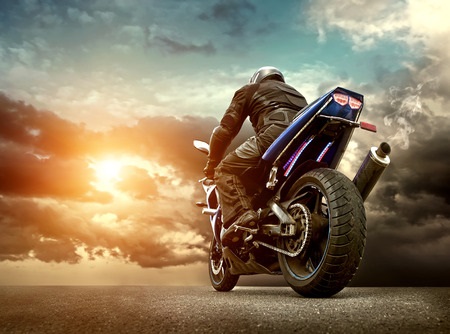 Motorcycle on Open Road with Intense Clouds